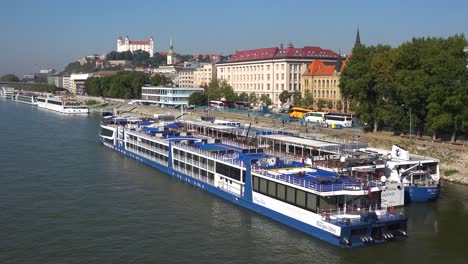 boats travel on the danube river through the charming capital city of bratislava slovakia