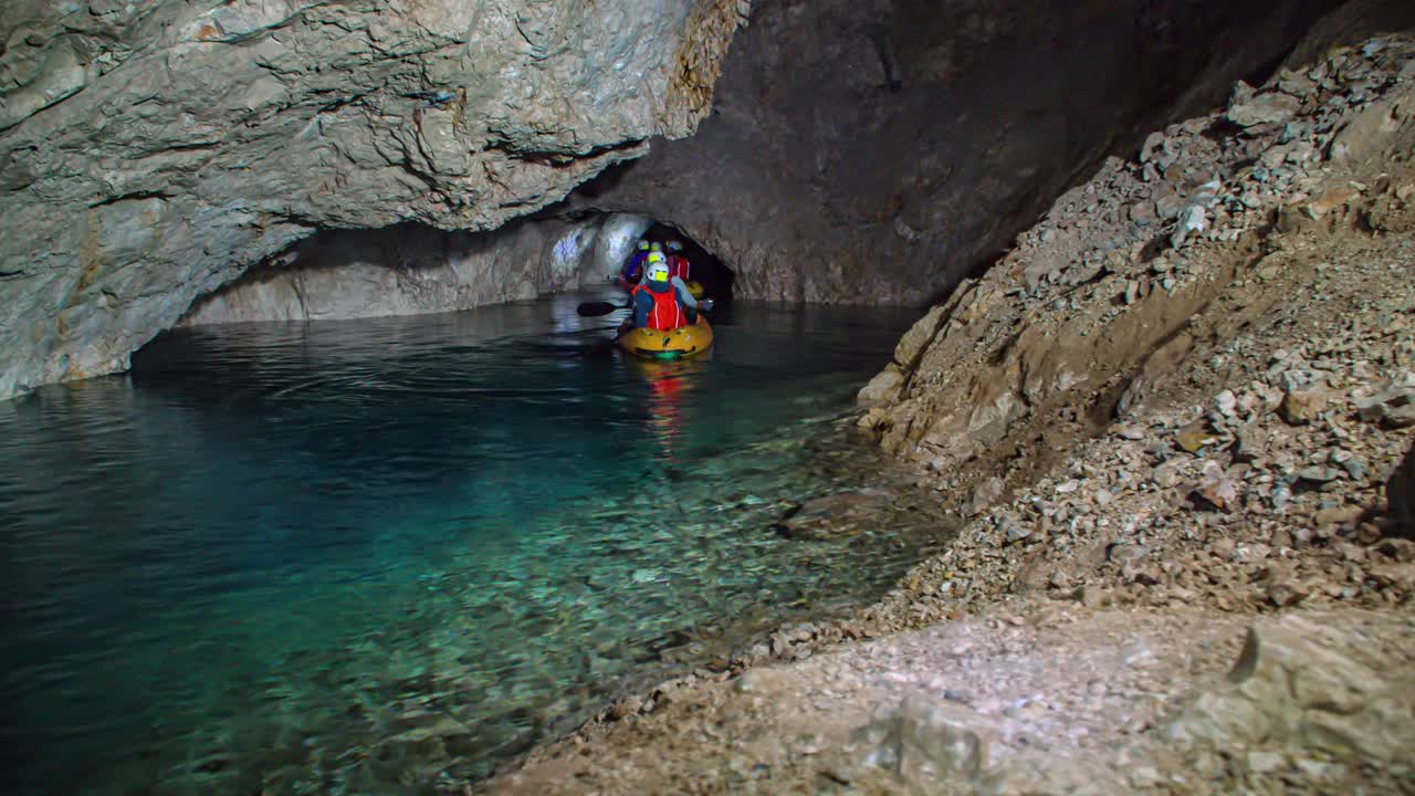 friends kayaking mysterious caverns, pristine water of Mezica mine