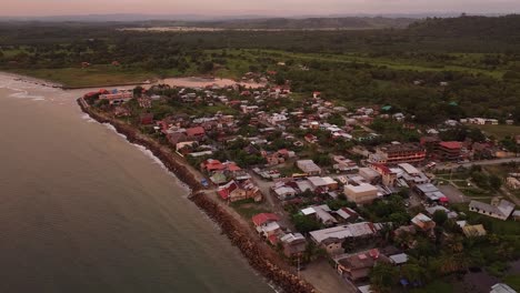 aerial push in reveal of mompiche ecuador. esmeraldas province of ecuador. rainforest beach town coast of ecuador. pacific coast surf town.