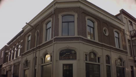 old ijmuiden - netherland - january 21st 2019 : looking up camera angel of a classical vintage building in dutch neighborhood during winter