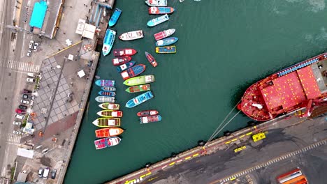 aerial view over water fishing boats red ship valparaiso port harbor chile day