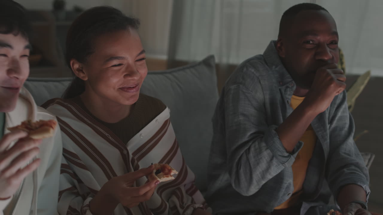 Mates Eating Pizza and Watching Comedy