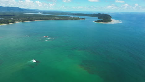 aerial flying over turquoise sea on coast of khao lak, thailand