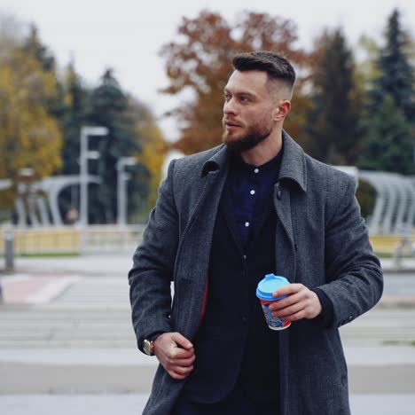 Businessman holding coffee cups on street