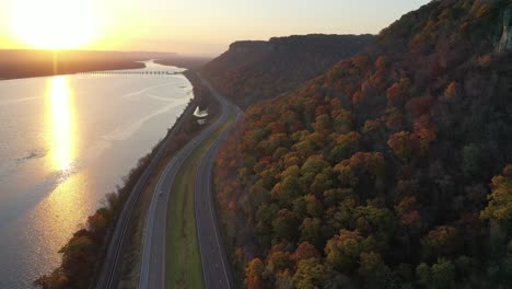 autumn sunrise over river and highway