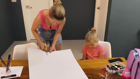 mother and daughter making circles from paper