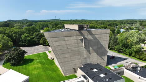 Brutalist-church-of-stone,-slow-high-rotation-to-face-it