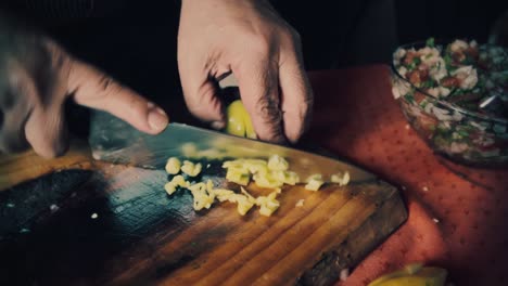 cutting green pepper on a old style the cutting board to make a chilean organic salad