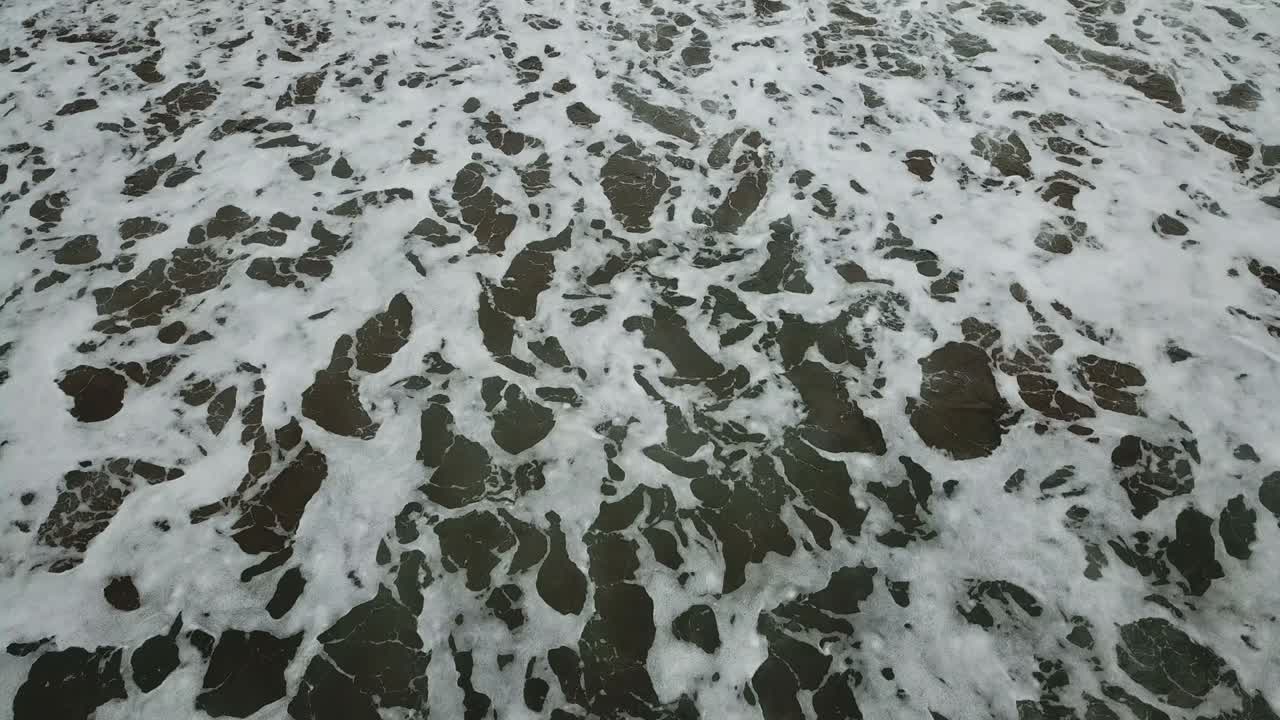 vista aérea de los pájaros mirando hacia abajo a las olas del mar que se estrellan. verde y azul vista superior del mar dron, imágenes de drones