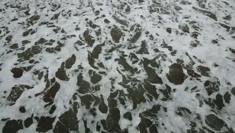 aerial birds eye view looking down at sea waves crashing down. green and blue sea top view drone, drone footage