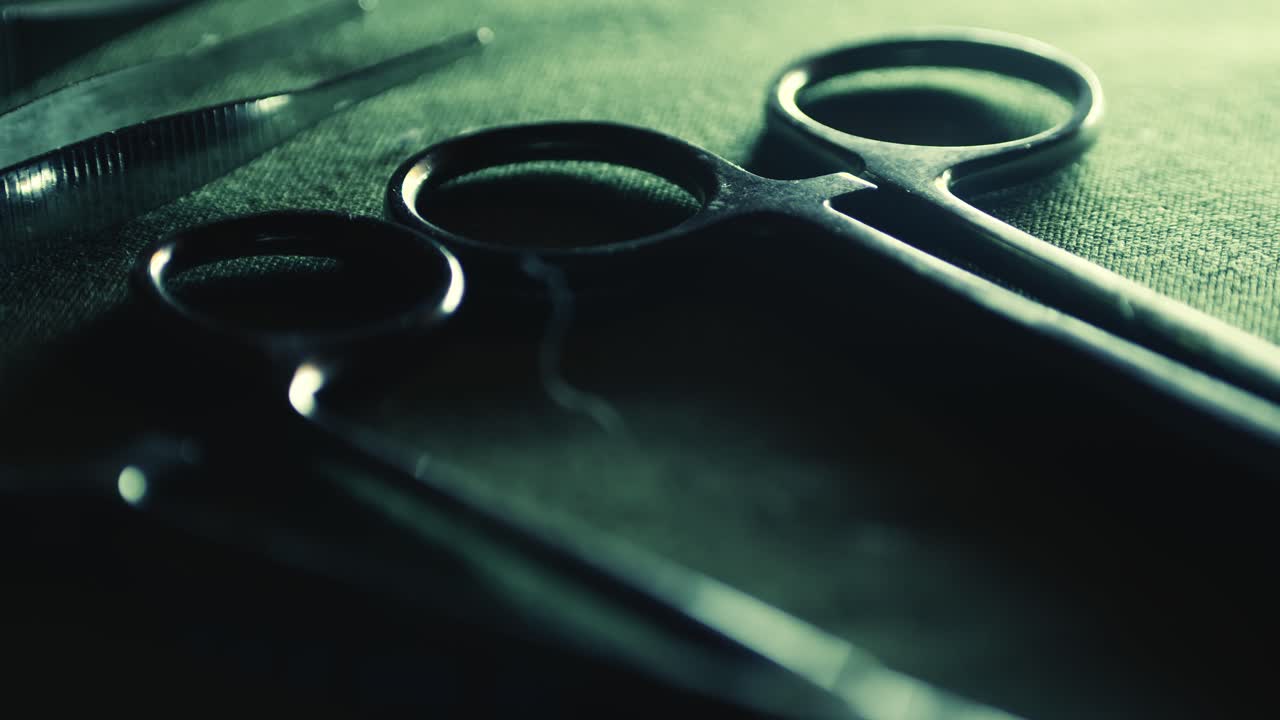 Surgical medical instruments laid out on green cloth CLOSE-UP reveal