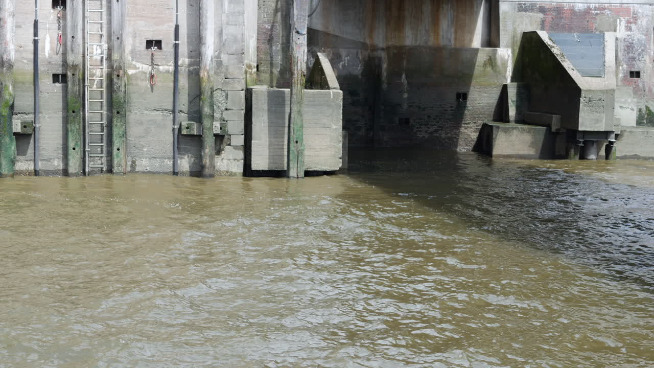 Flowing muddy waters and Quay at daylight.