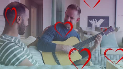 Animation-of-heart-icons-over-diverse-gay-couple-smiling-and-playing-guitar