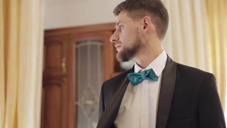 novio con camisa blanca y chaqueta en casa. día de la boda. hombre guapo