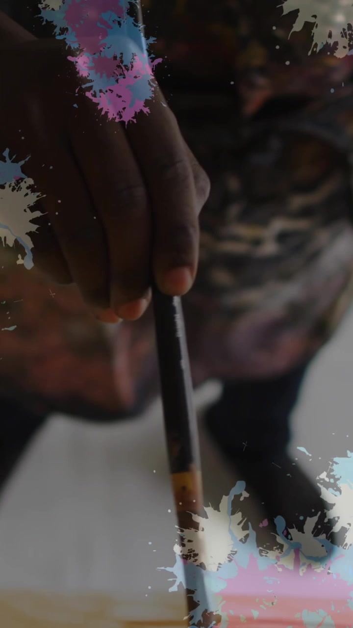 Animation of stains over african american man painting