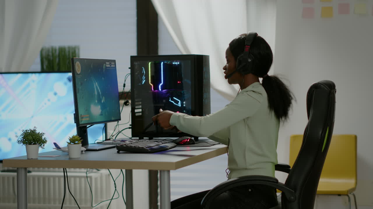 Black woman gamer winning videogames using professional wireless controller