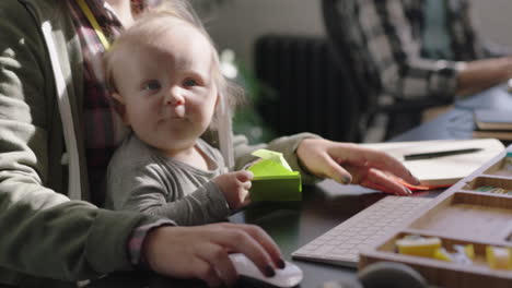 young caucasian business woman mother playing with baby daughter at work playful toddler enjoying loving mom successful motherhood in office workplace