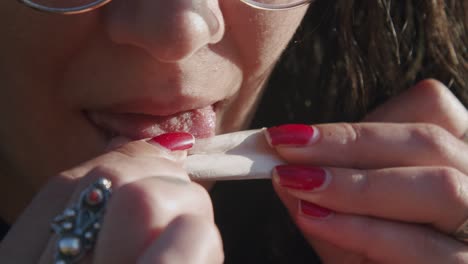 Girl-Rolling-A-Cigarette---Girl-Licking-The-Cigarette-Paper-And-Preparing-To-Smoke