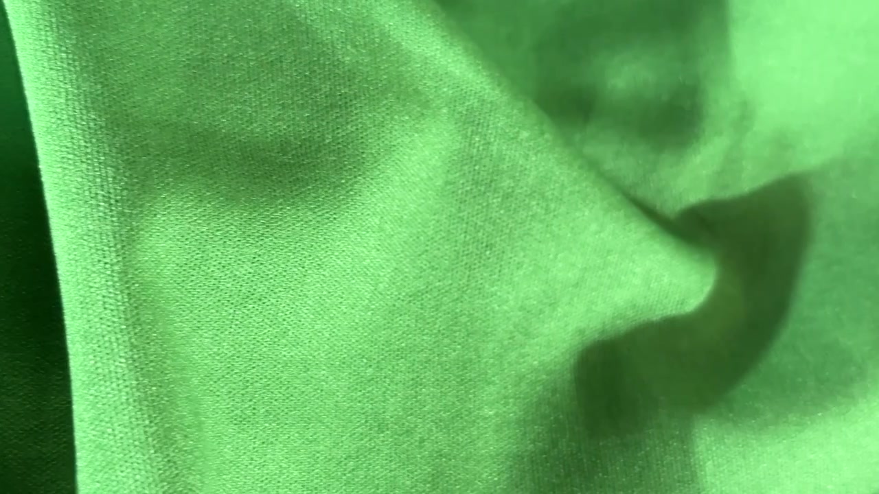 Close-up of Green Fabric Texture with Soft Folds