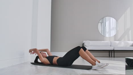 home fitness concept. woman doing abs crunches on floor at home copy space