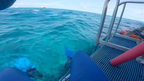 man playing with swim noodle preparing to snorkel