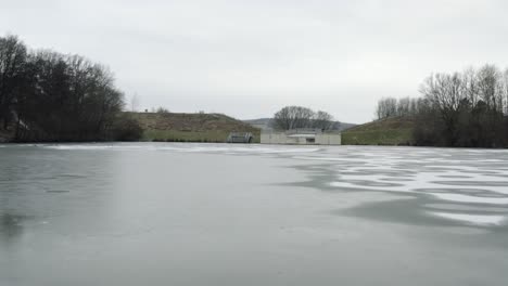 drone aerial footage of a 4k drone flying very close over a frozen lake in germany