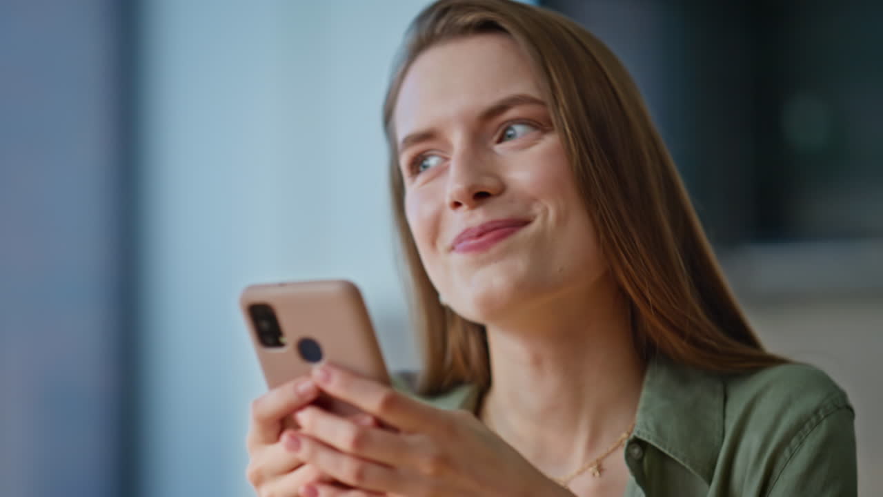 Positive woman taking smartphone sitting at breakfast closeup. Smiling lady