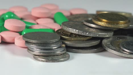 Close-Shot-of-Pills-and-Coins