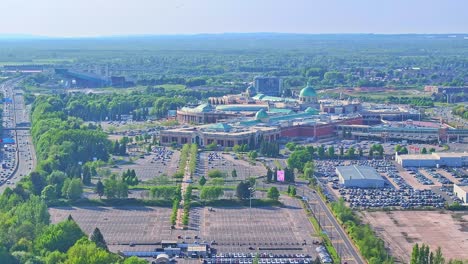 aerial: trafford centre large indoor shopping centre during the day in trafford park, greater manchester, england, establishing drone shot