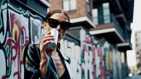 stylish woman enjoying a drink in the city