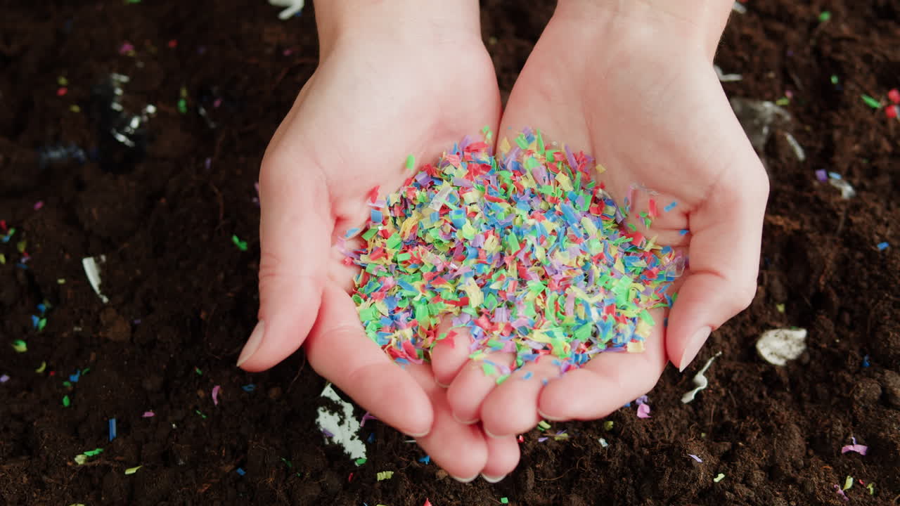 Woman Holding Recycled Plastic Pieces in Her Hands