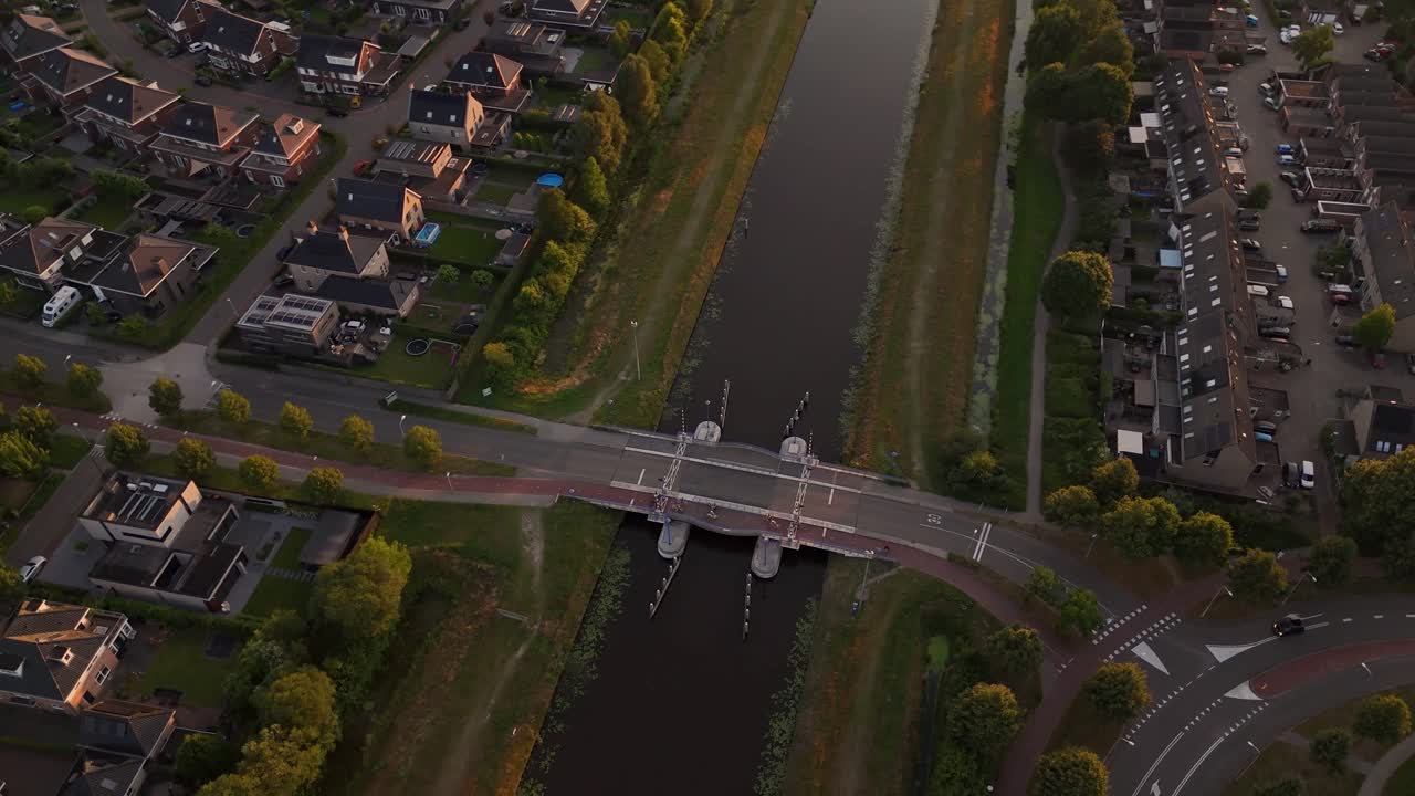 Aerial View of a Suburban Neighborhood with Canal and Bridge