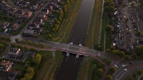 aerial view of a suburban neighborhood with canal and bridge