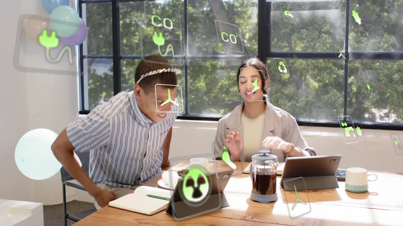 Woman presenting phone and explaining energy data, man reacting and standing, green icons floating