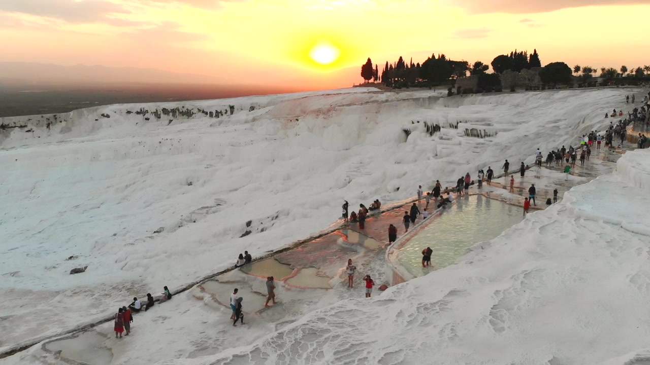 Tourists Visiting Pamukkale Travertine Terraces at Sunset