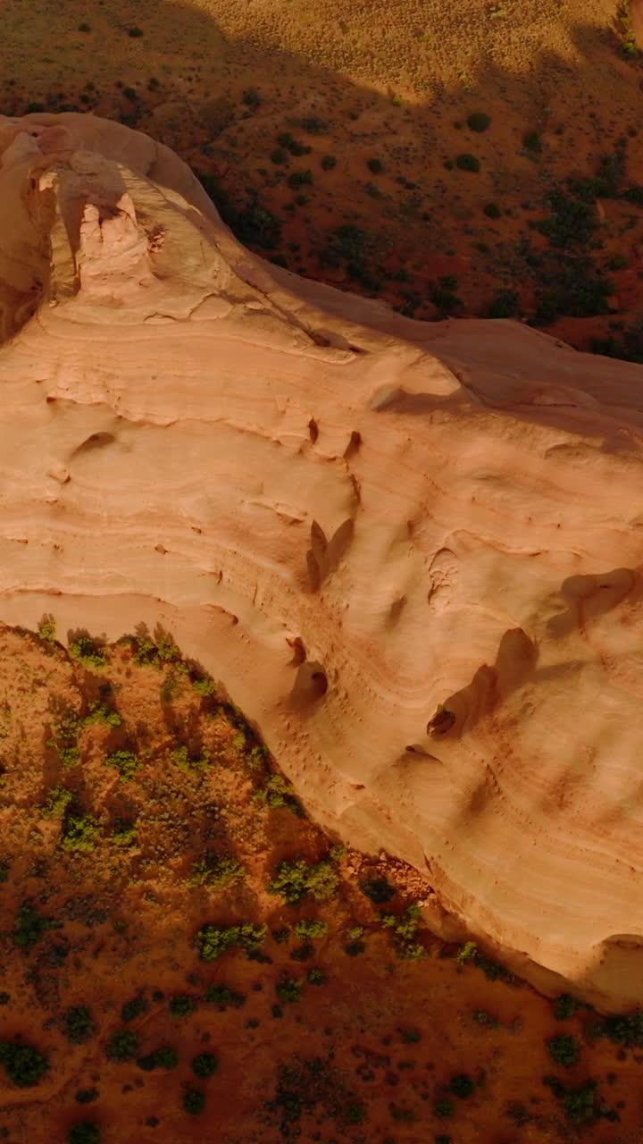 Beautiful rock formations with rounded sides from air erosion. Drone footage over the amazing canyons in Utah, USA. Vertical video