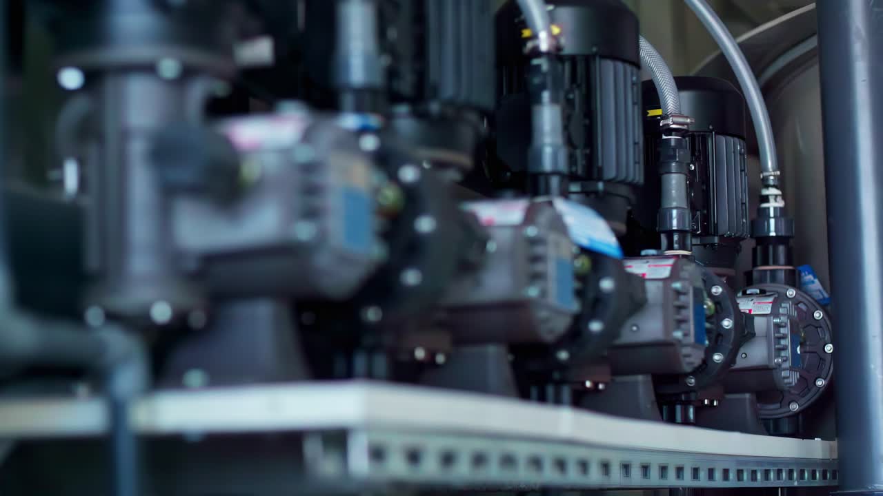 Automated machinery engines in rack focus between metal components and no mechanical action
