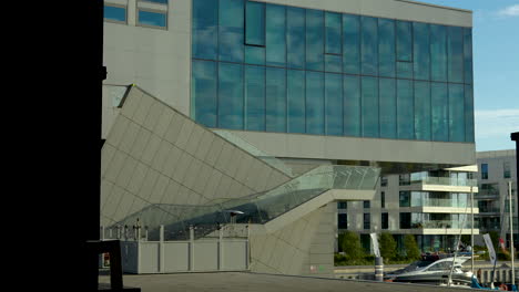 contemporary building with angular glass facade in daylight