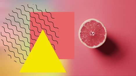 composición de pomelo dividido en dos y formas abstractas sobre fondo rojo