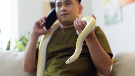 Man with snake talking on the phone