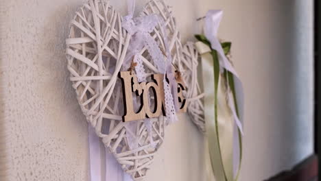 wooden woven heart decorates a wall for wedding ceremony