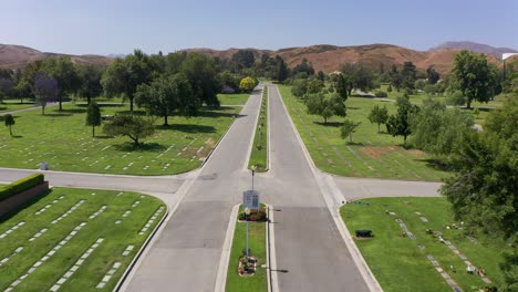 Low-aerial-shot-flying-over-the-main-road-of-a-mortuary-in-California