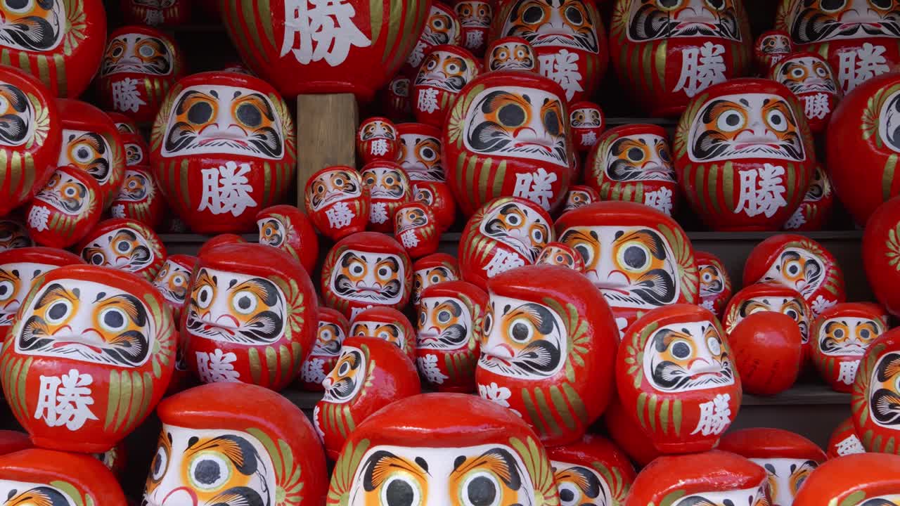 Dolly in towards dozens of Daruma statues at Katsuoji shrine near Osaka, Japan