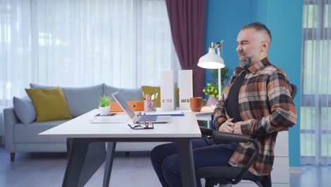 man with stomach ache is writhing in pain.