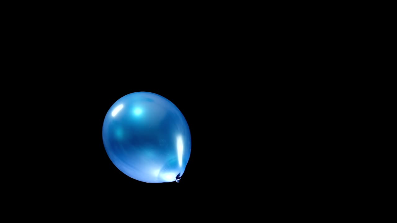 A single blue balloon falls slowly from top to bottom, with its graceful descent and radiant shine creating a calming, tranquil effect. The simple yet elegant motion stands out against the background.