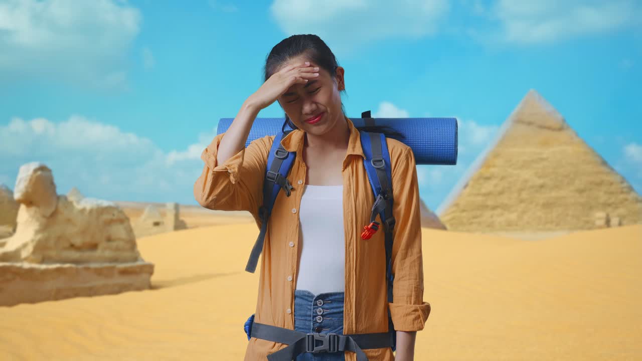 Asian Female Hiker With Mountaineering Backpack Having A Headache While Traveling In Pyramid Of Giza