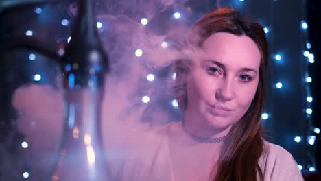 woman enjoying hookah in a nightclub