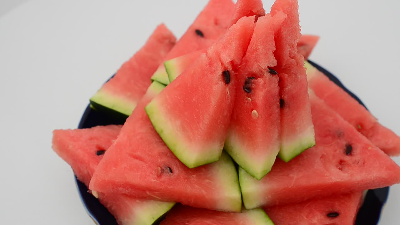 Shooting of a watermelon on a white background. Shooting in the movement