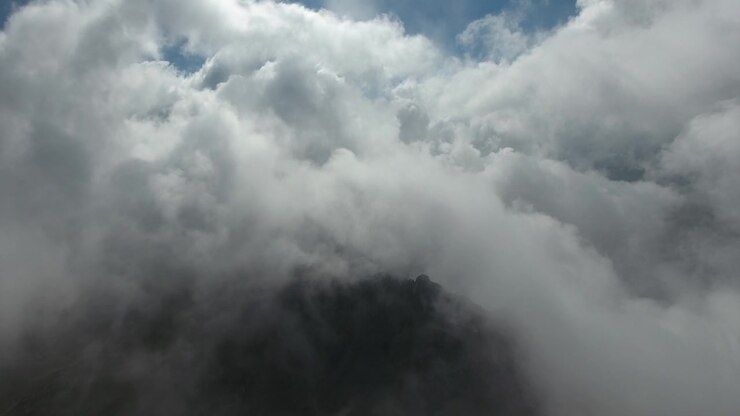 Aerial View Flying Through Dense White Clouds