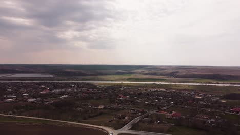 Aerial-View-Of-Small-Village-Surrounded-By-Water